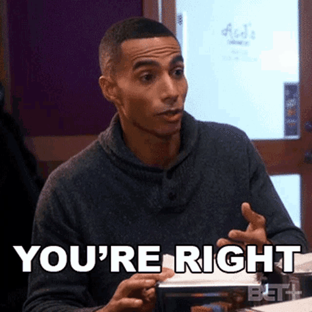a man sitting at a table with the words " you 're right " on the screen
