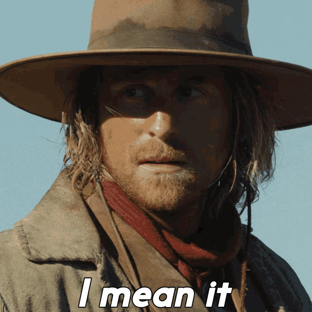 a man wearing a cowboy hat and scarf says i mean it