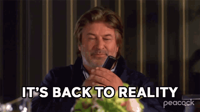 a man is talking on a cell phone and the words it 's back to reality are above him