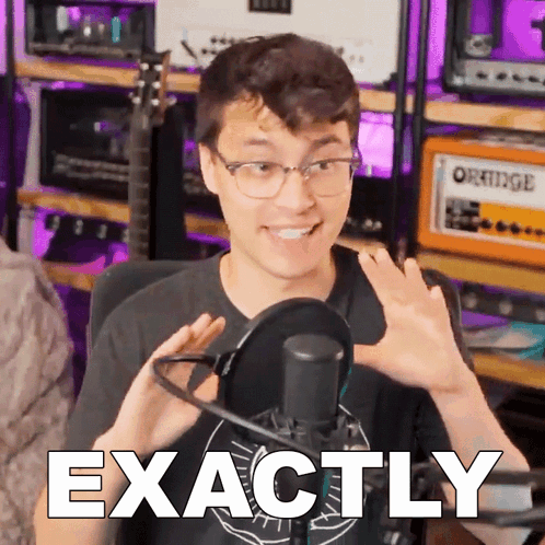 a man in front of a microphone with the word exactly on the bottom