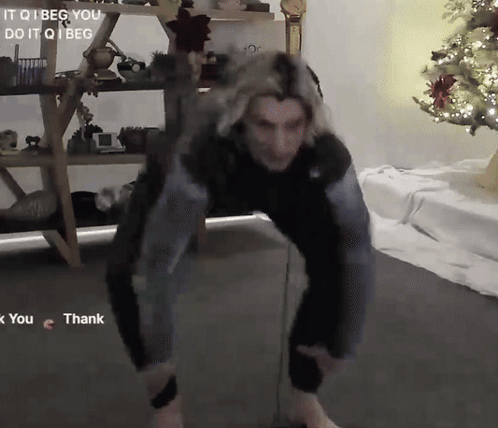 a person dancing in front of a christmas tree with the words it qi beg you do it qi beg on the bottom