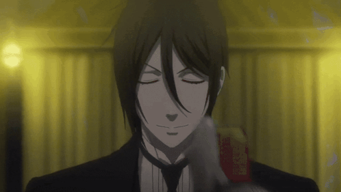 a man in a suit and tie with his eyes closed holds a book