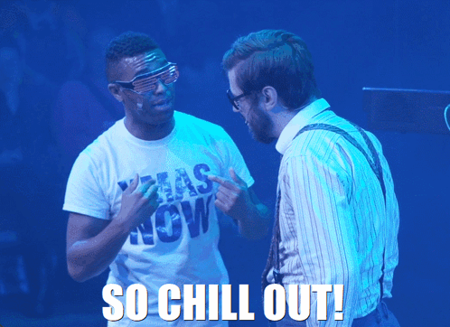 Two men on a blue-lit stage argue beneath “SO CHILL OUT!”