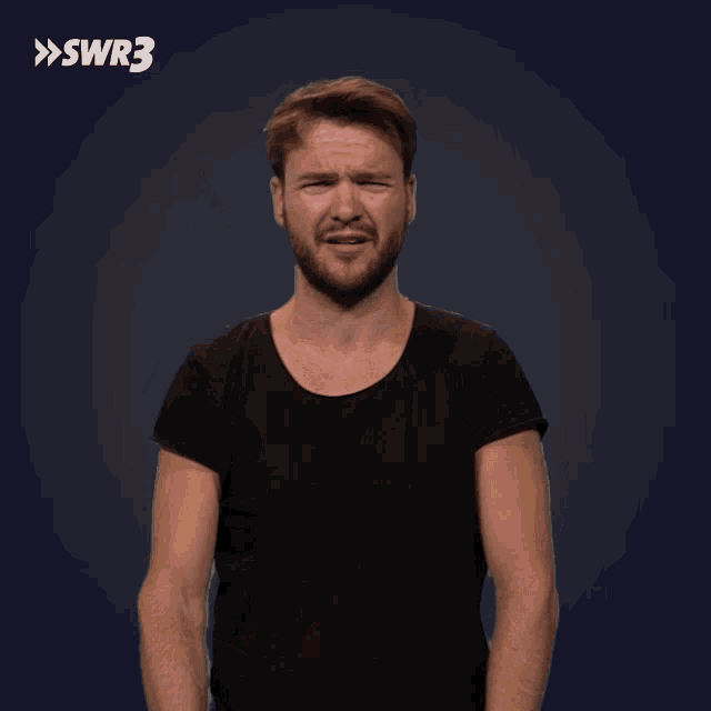 a man in a black shirt is making a funny face in front of a blue background with swr3 written on it