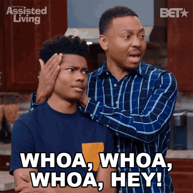 a man is putting his hand on another man 's head and says " whoa "