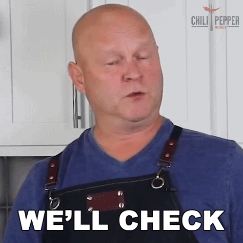 a man wearing a blue shirt and black apron says we 'll check