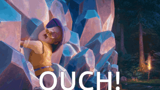 Mayor Humdinger grimaces while caught among glowing crystal formations with “OUCH!” text.