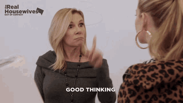 a woman says good thinking in front of a real housewives poster