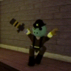 a toy police officer with a green head is standing on a sidewalk holding a baton .
