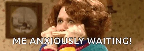 a woman is covering her mouth with her hands while talking on a cell phone .