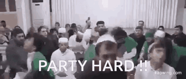 a group of people are dancing in a room with the words `` party hard '' written on the screen .