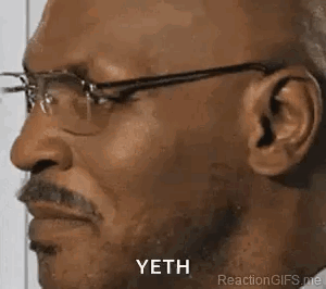 A man wearing glasses smiles in profile with a small “YETH” caption.