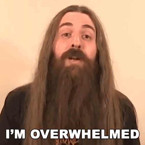 a man with a beard and long hair is saying i 'm overwhelmed .