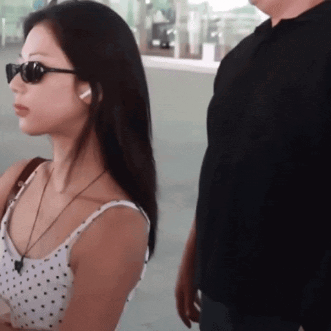 a woman wearing sunglasses is standing next to a man
