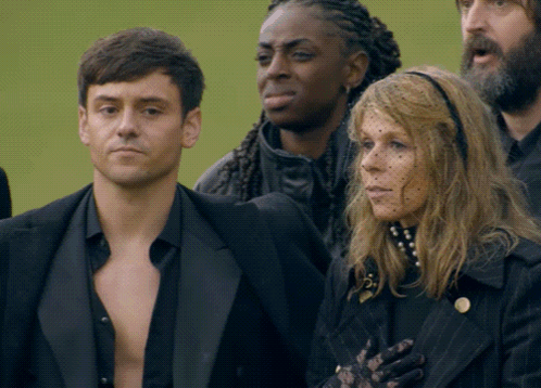 a man and a woman are standing next to each other in a crowd