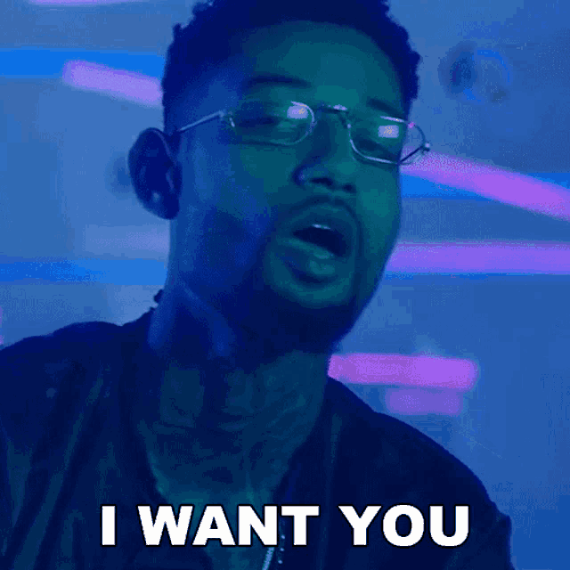 a man with glasses says i want you with his mouth open
