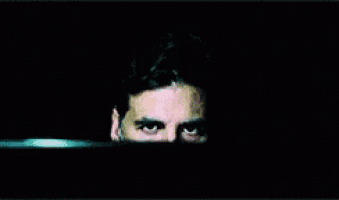 a close up of a man 's eyes with a beard
