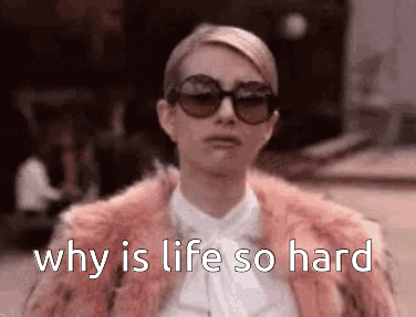 A woman in sunglasses looks down sadly with the caption “why is life so hard.”