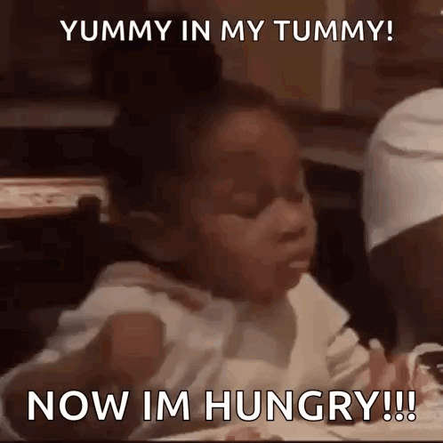 A child eats as captions say “YUMMY IN MY TUMMY!” and “NOW I'M HUNGRY!!!”