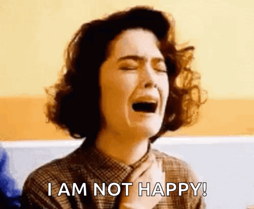 A woman cries intensely with the caption “I AM NOT HAPPY!”