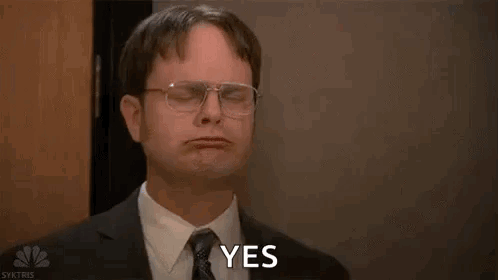 Dwight Schrute sits stone-faced with a small “YES.” caption.