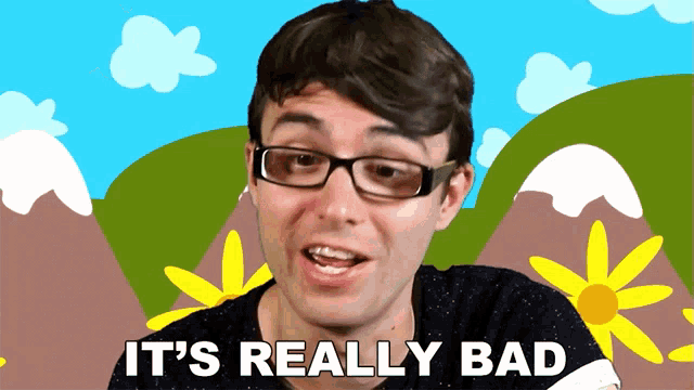 a man with glasses says it 's really bad in front of mountains and flowers