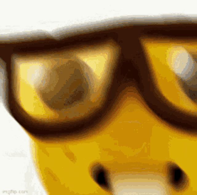 a close up of a yellow object wearing sunglasses .