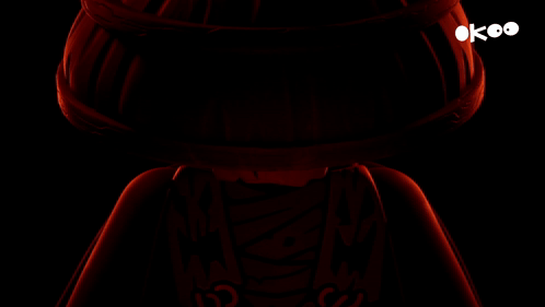 a lego figure with red eyes and a black background with the letters ok on it