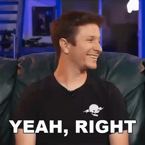 a man in a black shirt is sitting on a couch and smiling with the words " yeah , right " below him .