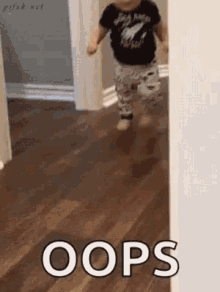 A toddler runs in a hallway with the caption “OOPS.”