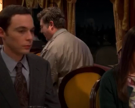 a man in a suit and tie sits at a table with the words fun fact written in white