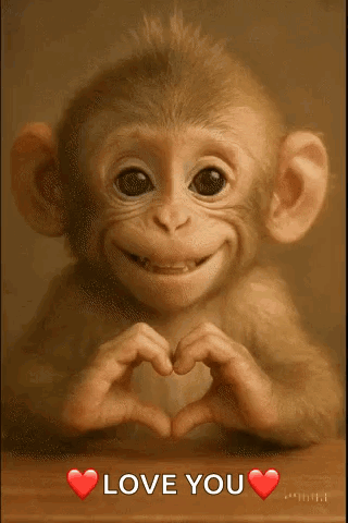 A baby monkey makes a heart with its hands above “LOVE YOU.”