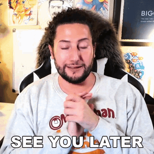 a man with a beard is wearing a sweater that says " see you later " on it