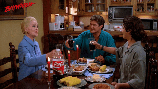 a group of people are sitting at a table with a coca cola bottle on the table