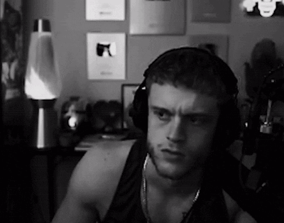 a black and white photo of a man wearing headphones in a room .