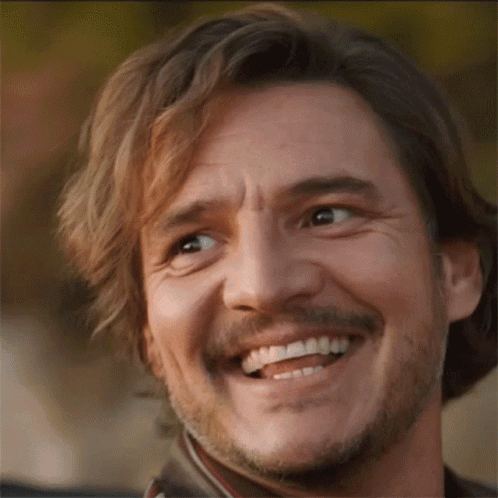 Pedro Pascal smiles warmly in a close-up reaction shot.
