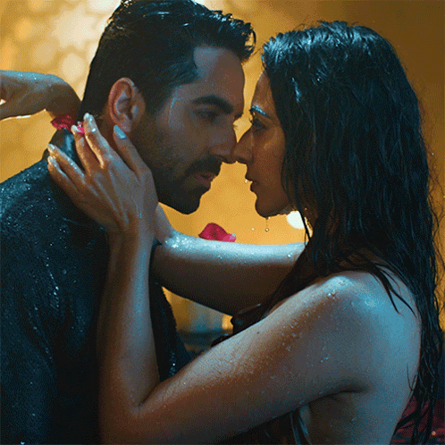a man and woman are kissing in the rain and the woman is touching the man 's face