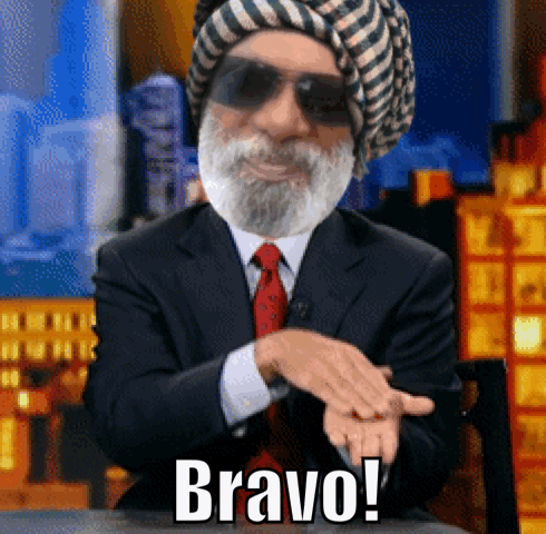A bearded man in a suit claps while the caption reads “Bravo!”