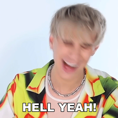 a man in a colorful shirt is laughing and says hell yeah