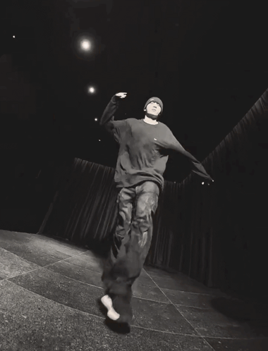 a black and white photo of a person wearing jeans