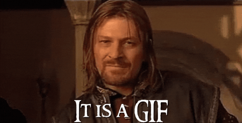 a man with long hair and a beard is smiling and saying it is a gif .