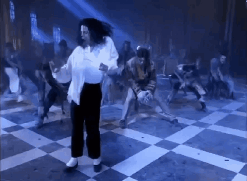 Michael Jackson dances in a blue-lit ballroom scene from Ghosts.