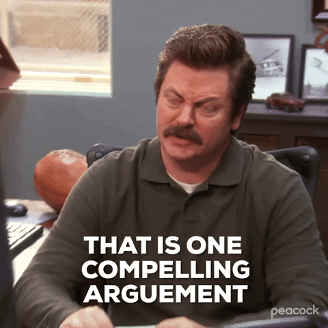 a man with a mustache is sitting at a desk and says " that is one compelling argument "