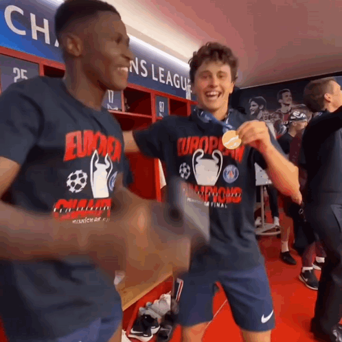 two soccer players in a locker room wearing shirts that say europa champions league