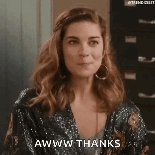 a woman in a sequined jacket is making a funny face and saying awww thanks .