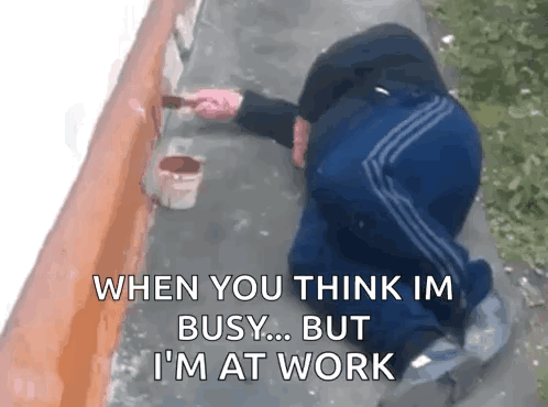 A person crouches by a wall with the caption “WHEN YOU THINK I’M BUSY... BUT I’M AT WORK.”