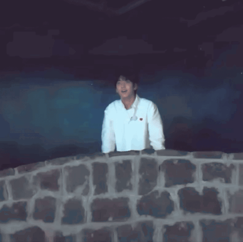 a man in a white shirt with a heart on it is dancing
