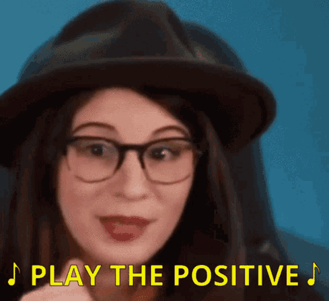 a woman wearing glasses and a hat with the words play the positive above her