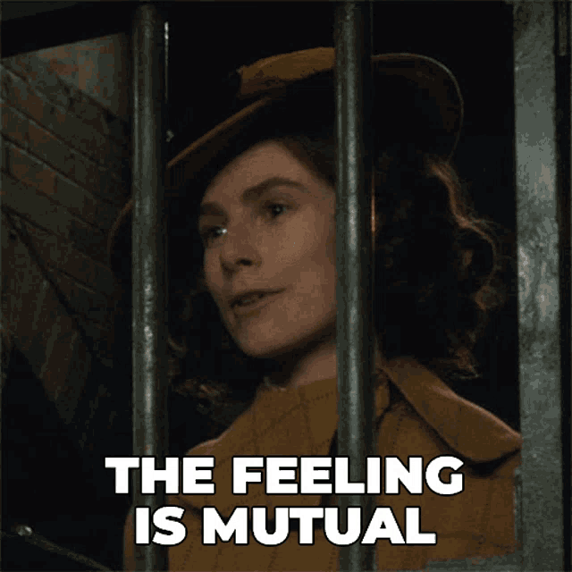 a woman behind bars with the words the feeling is mutual below her