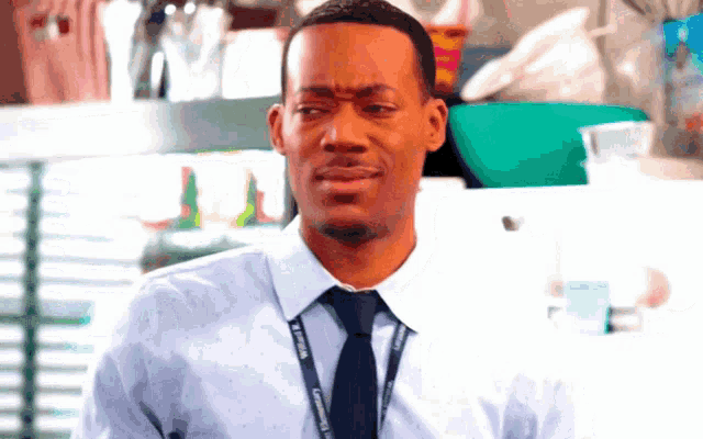 a man in a blue shirt and tie with a lanyard that says ' columbia ' on it